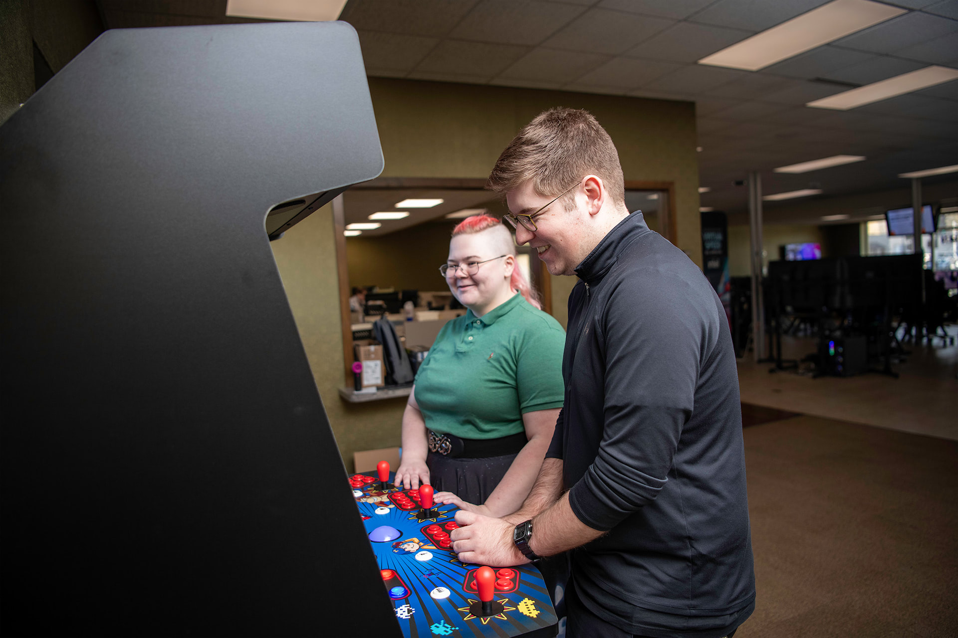 Two people playing a classic arcade game together