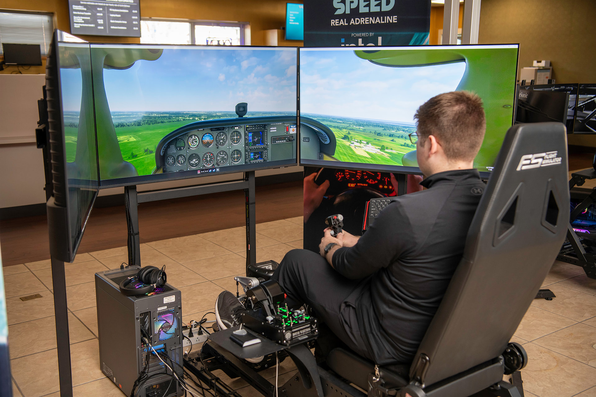 Person flying a virtual aircraft in a flight simulator using a VR headset