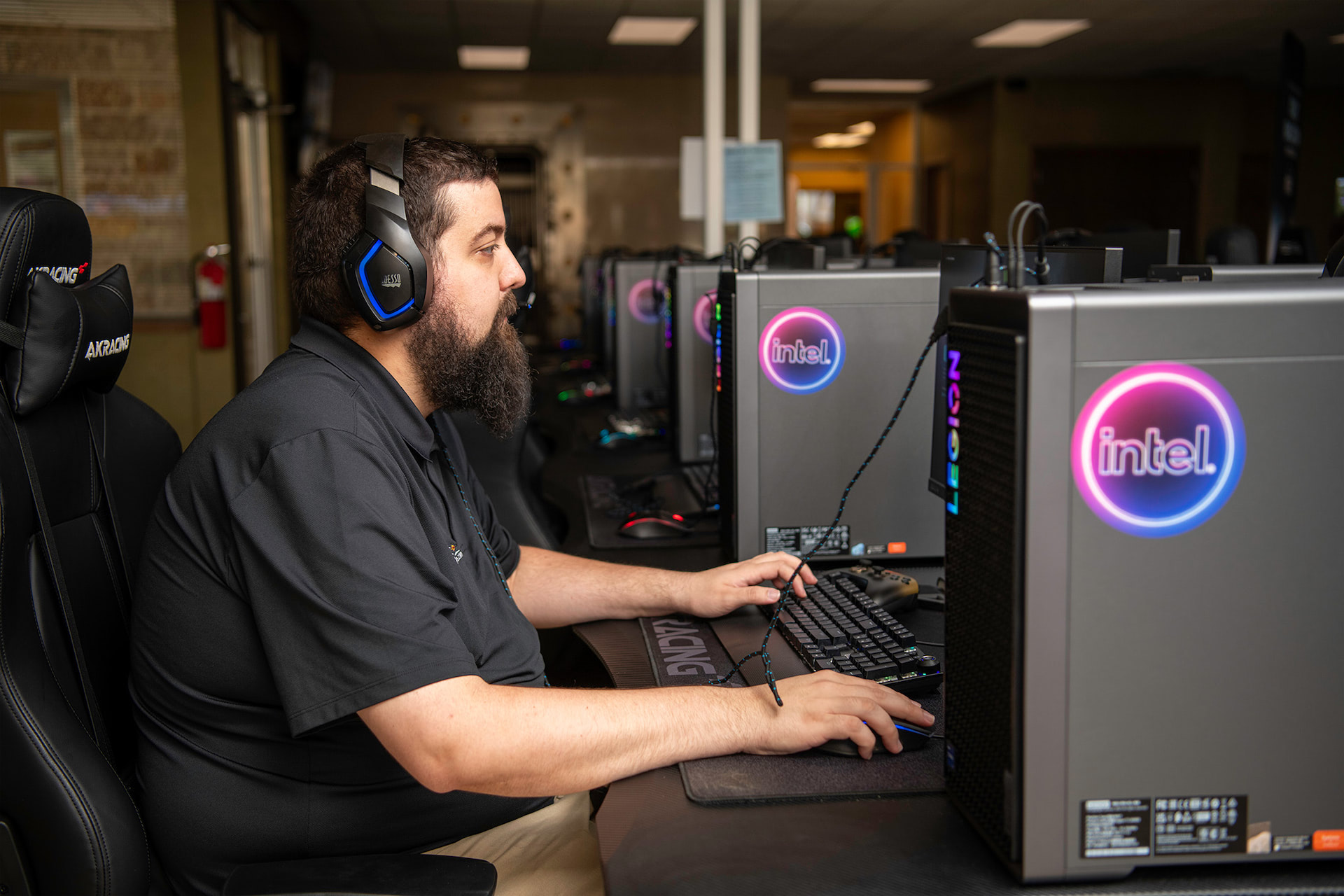 Side view of a person playing on a gaming PC