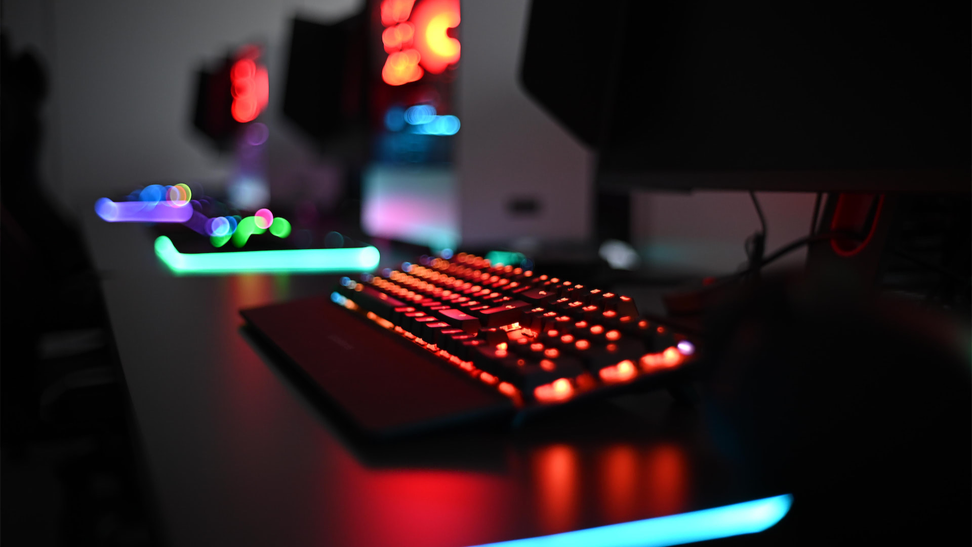 glowing keyboard infront of a computer monitor